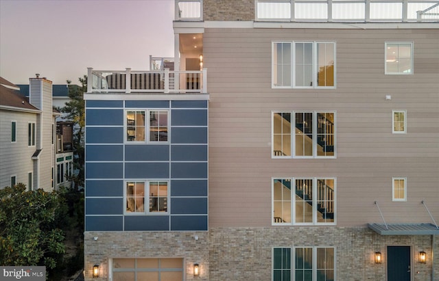 view of outdoor building at dusk