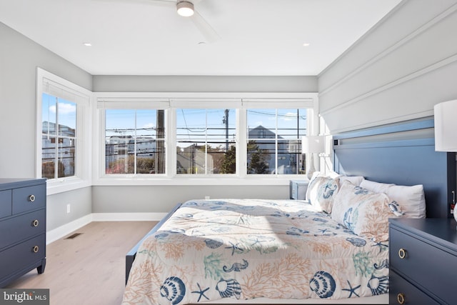 bedroom with light wood-type flooring and ceiling fan