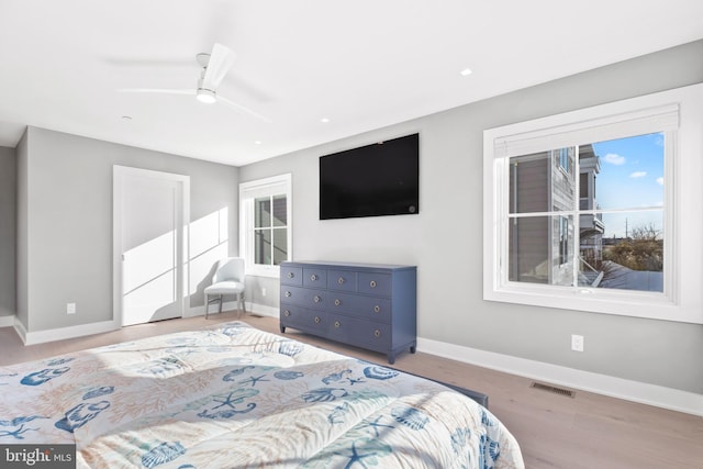 bedroom with light hardwood / wood-style flooring and ceiling fan