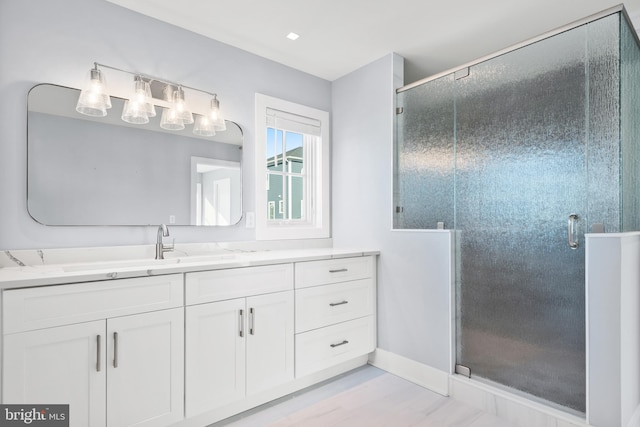 bathroom featuring vanity and an enclosed shower