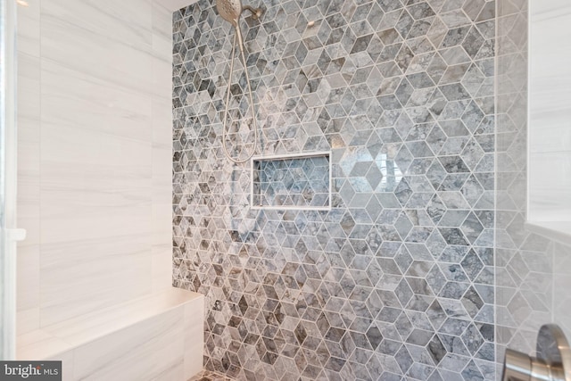 bathroom with tiled shower