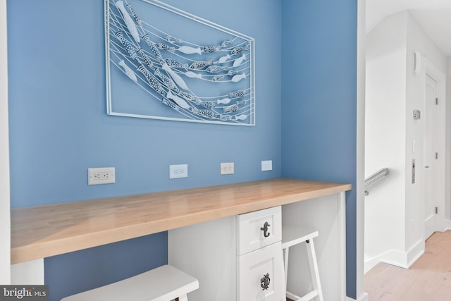 room details featuring hardwood / wood-style floors and built in desk