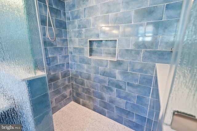 bathroom with a tile shower