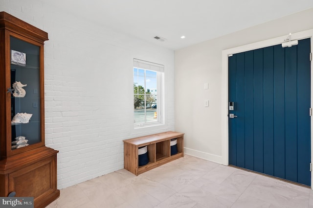 entrance foyer with brick wall