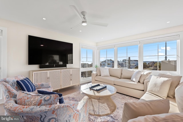 living room featuring ceiling fan and hardwood / wood-style flooring