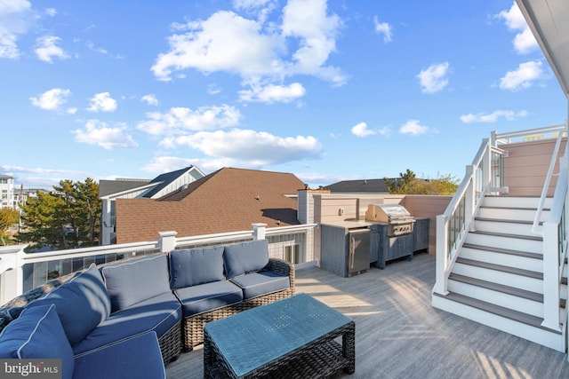 deck featuring outdoor lounge area and grilling area