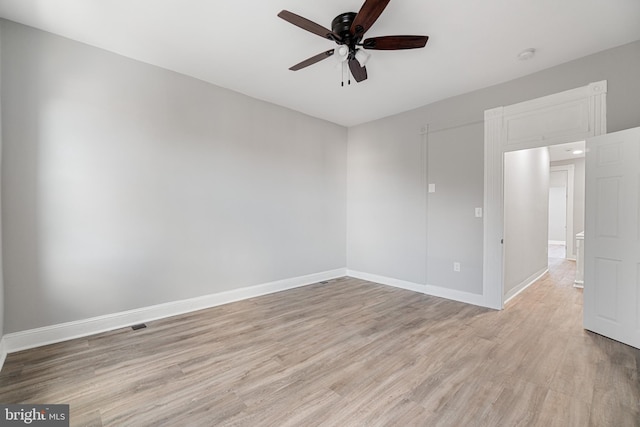 spare room with light hardwood / wood-style flooring and ceiling fan