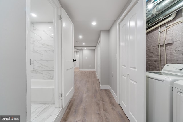 interior space with washer and clothes dryer and light wood-type flooring