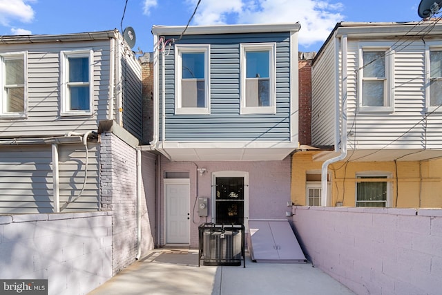 entrance to property featuring central AC unit and a patio