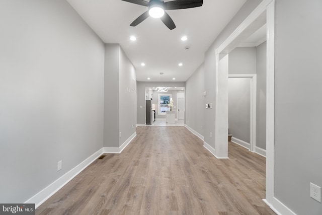 corridor with light hardwood / wood-style flooring