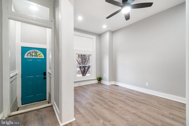 foyer entrance with light hardwood / wood-style flooring and ceiling fan