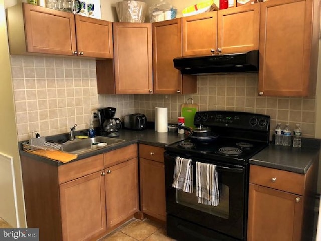 kitchen featuring backsplash, sink, black electric range oven, and light tile patterned floors