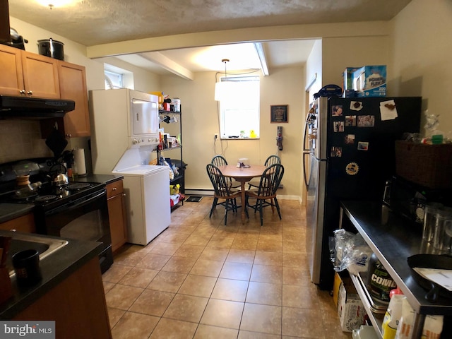 kitchen with hanging light fixtures, electric range, light tile patterned floors, a textured ceiling, and stainless steel refrigerator