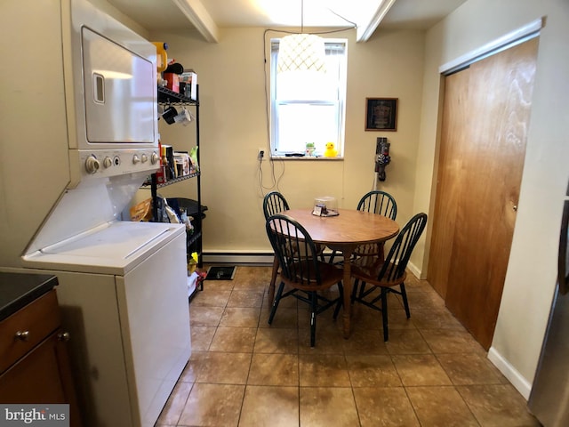 tiled dining area with beam ceiling and baseboard heating