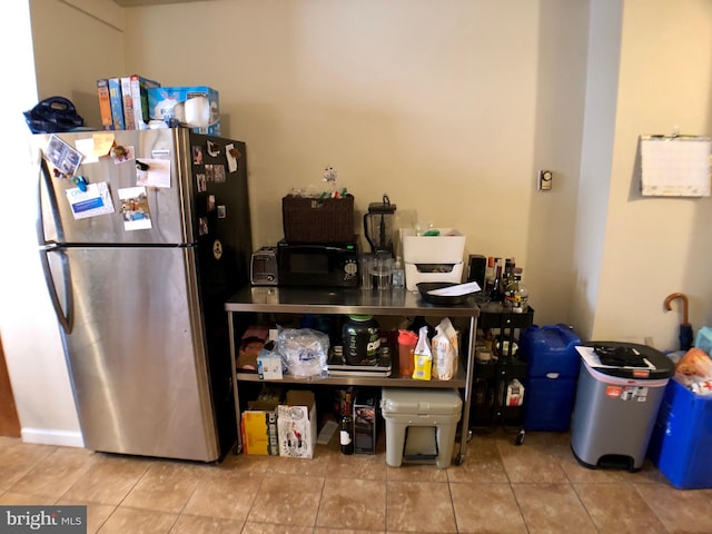 kitchen featuring stainless steel refrigerator and tile patterned flooring