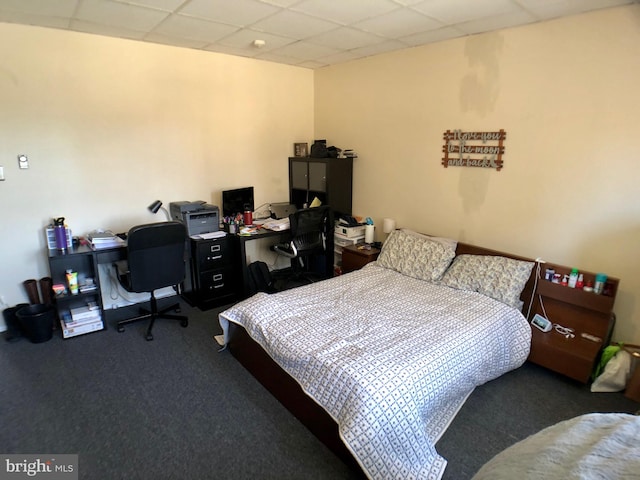 carpeted bedroom with a paneled ceiling