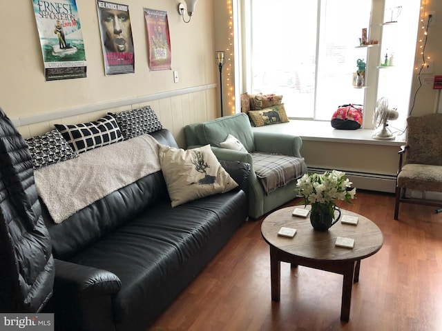 living room with hardwood / wood-style floors and a baseboard heating unit