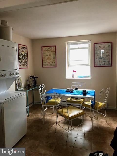 dining room featuring stacked washer and clothes dryer