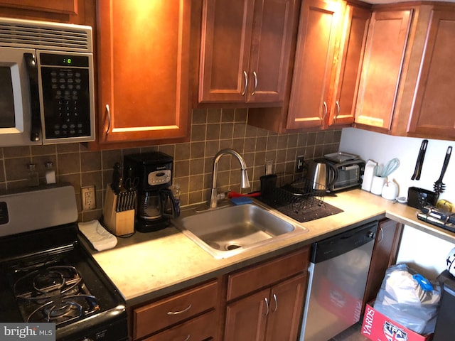 kitchen featuring sink, appliances with stainless steel finishes, and tasteful backsplash