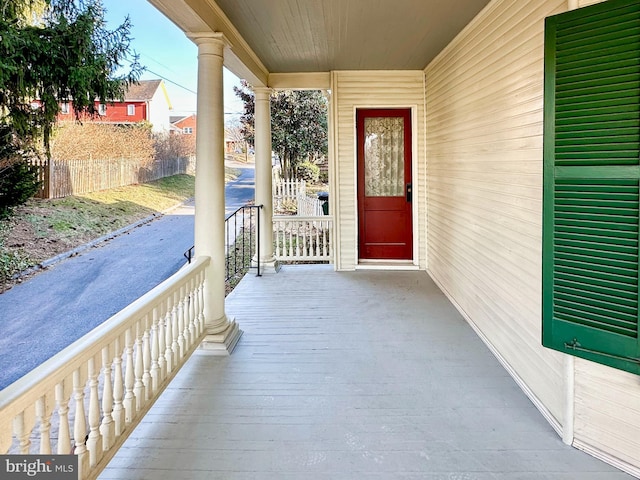 view of exterior entry featuring covered porch