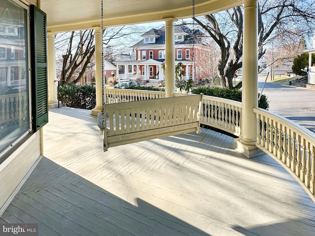 wooden deck with a porch and a residential view