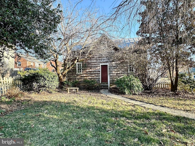 view of front of property with a front yard and fence