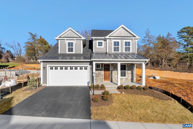 view of front of home featuring covered porch and a garage