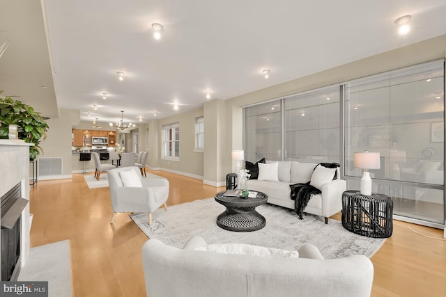 living room featuring light hardwood / wood-style floors and a chandelier