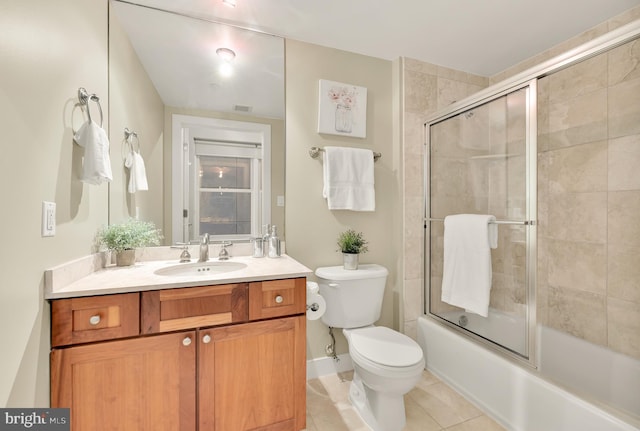 full bathroom featuring toilet, vanity, tile patterned floors, and shower / bath combination with glass door