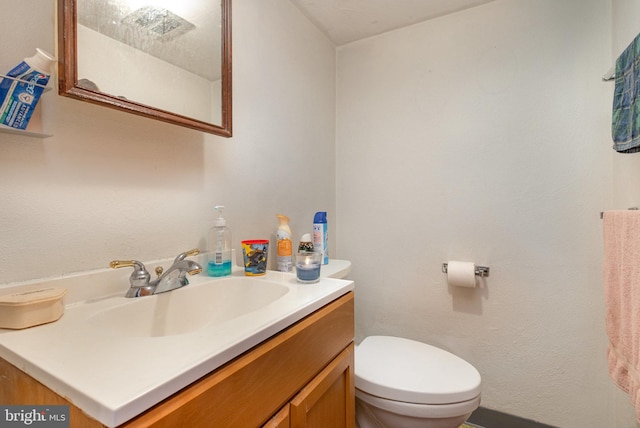 bathroom with toilet and vanity