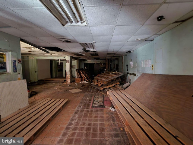 interior space with a paneled ceiling