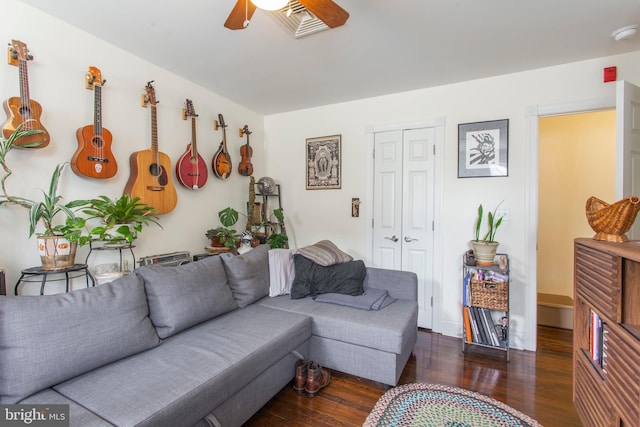 living room with ceiling fan and dark hardwood / wood-style flooring