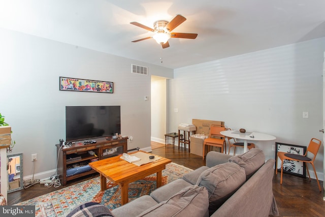 living room featuring ceiling fan and dark parquet floors