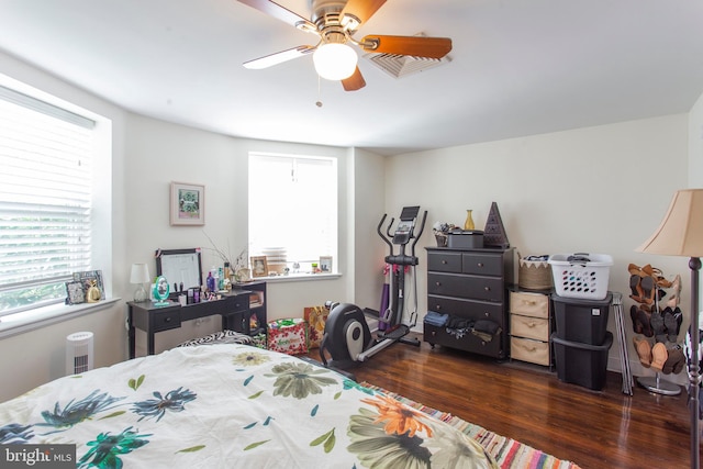 bedroom with dark hardwood / wood-style floors and ceiling fan