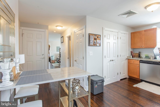 kitchen featuring stainless steel dishwasher and dark hardwood / wood-style floors