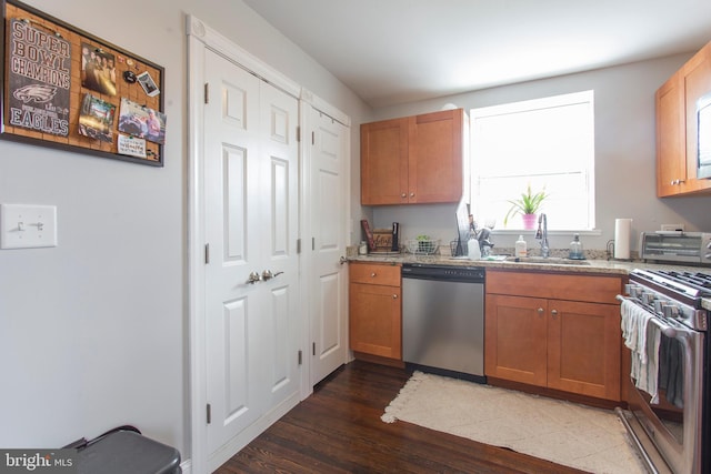 kitchen with dark hardwood / wood-style floors, sink, and stainless steel appliances