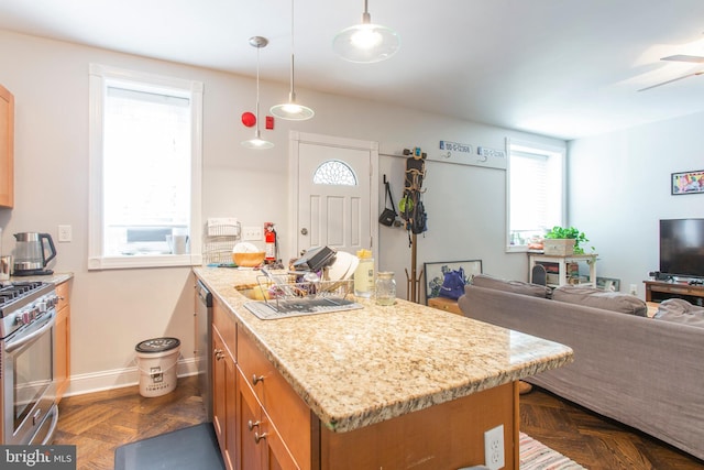 kitchen featuring high end stove, plenty of natural light, dark parquet floors, and pendant lighting