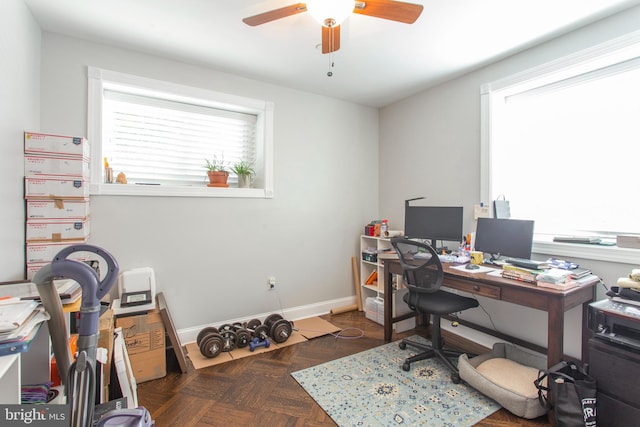 office space featuring dark parquet flooring and ceiling fan