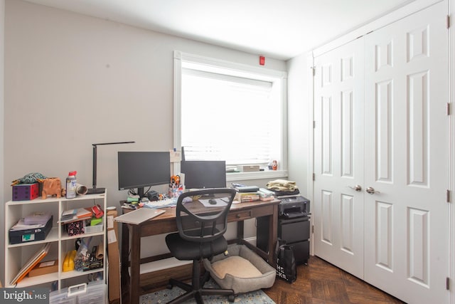 home office with dark parquet flooring