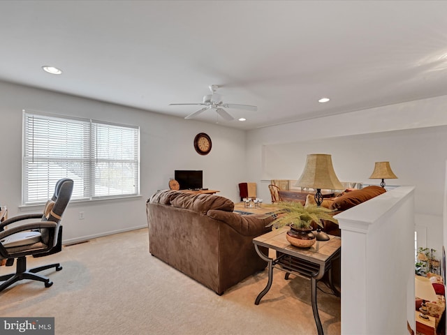 carpeted living room with ceiling fan