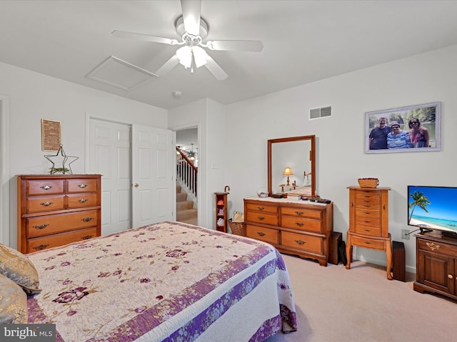 carpeted bedroom featuring ceiling fan and a closet