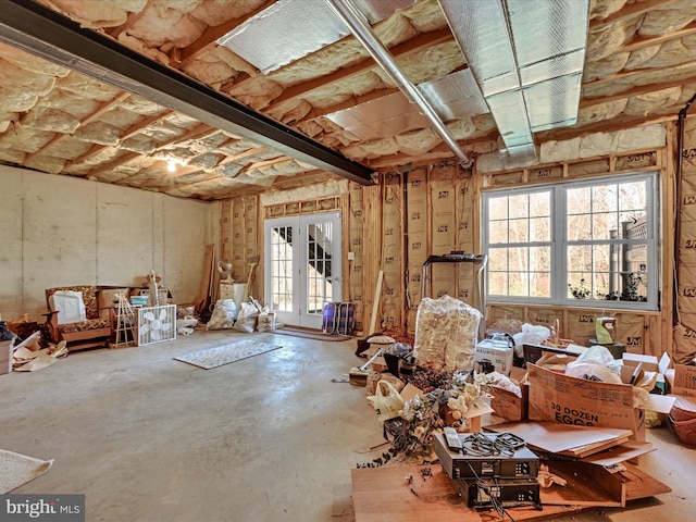 misc room with concrete flooring and french doors