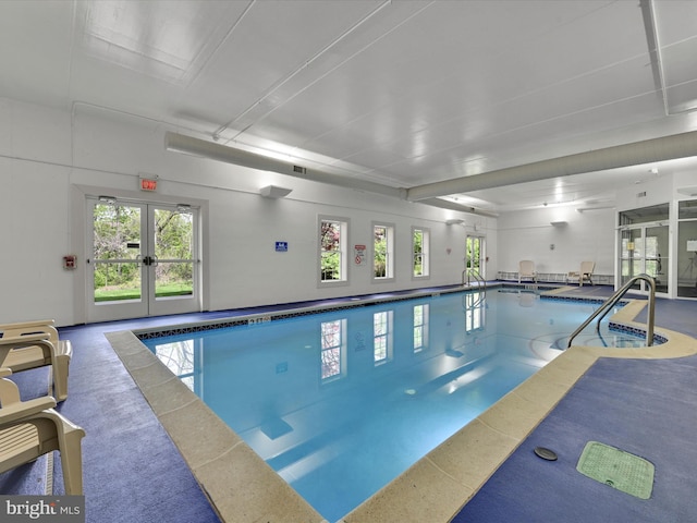 view of swimming pool featuring french doors