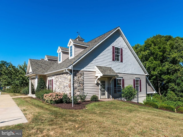 new england style home featuring a front yard