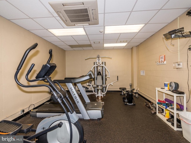 exercise room featuring a drop ceiling