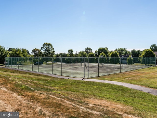 view of sport court with a lawn