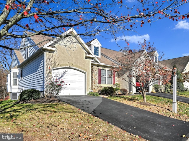 view of front of property with central AC unit and a front lawn