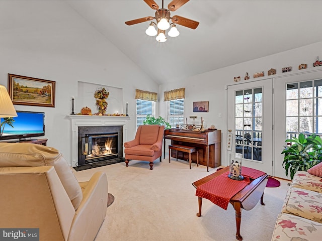 living room featuring high vaulted ceiling, light carpet, and ceiling fan