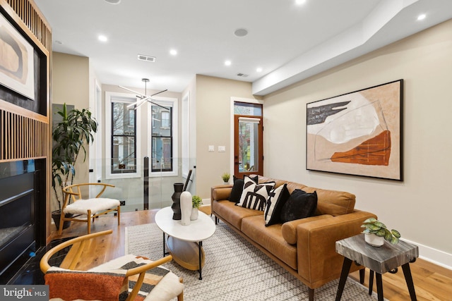 living room with wood-type flooring and a notable chandelier