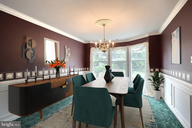 carpeted dining area with an inviting chandelier and crown molding